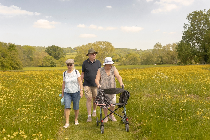 Visitors walking in the meadows at Lacock Abbey Wiltshire